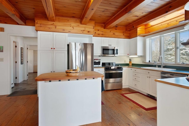 kitchen with white cabinetry, sink, stainless steel appliances, and light hardwood / wood-style floors