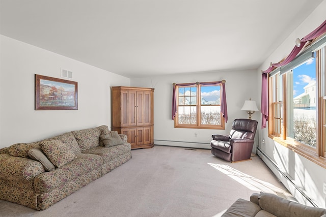 carpeted living room with a baseboard radiator and plenty of natural light