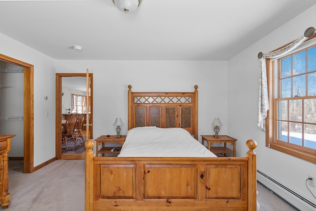 carpeted bedroom with a baseboard heating unit