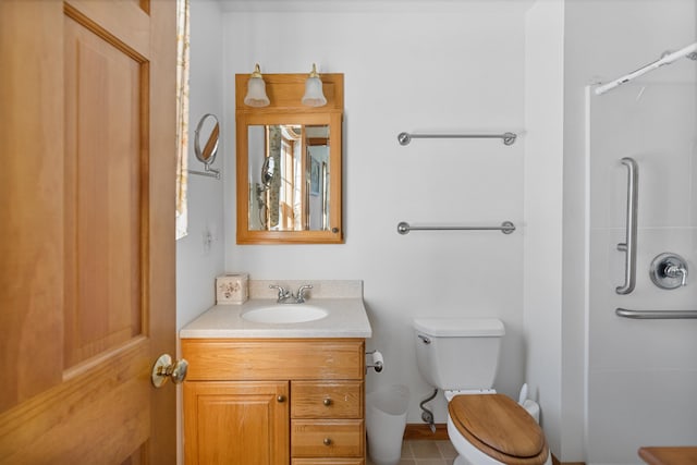 bathroom featuring vanity, toilet, and walk in shower