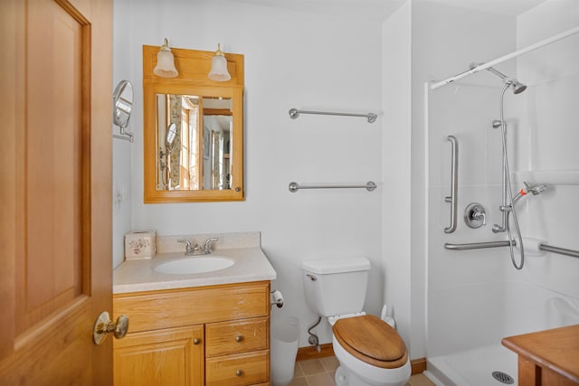 bathroom with tile patterned flooring, vanity, toilet, and walk in shower