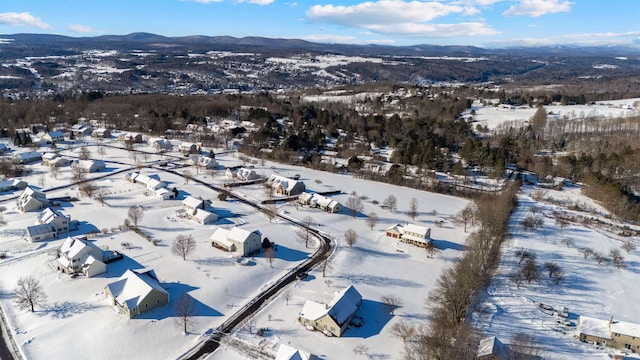 snowy aerial view featuring a mountain view