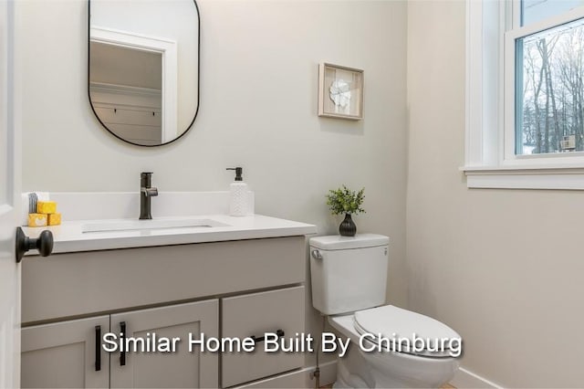 bathroom featuring vanity and toilet