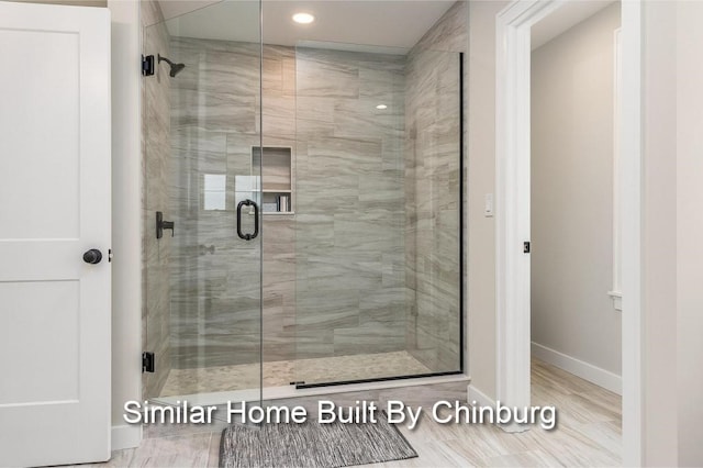 bathroom featuring a shower with door