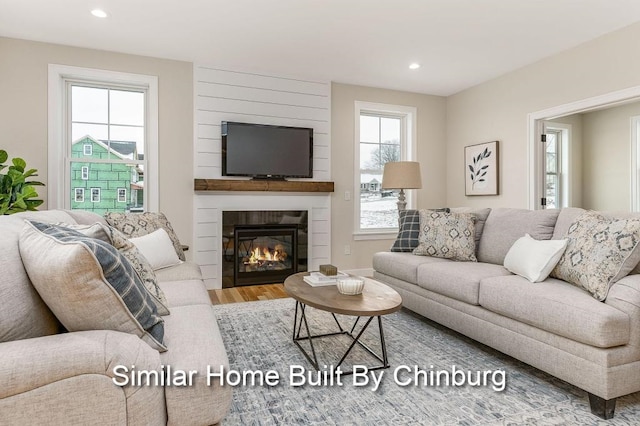 living room with hardwood / wood-style flooring and a fireplace