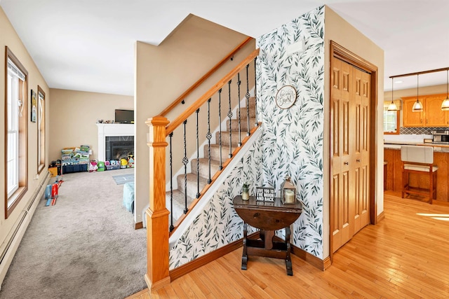 stairs featuring carpet flooring and a tile fireplace