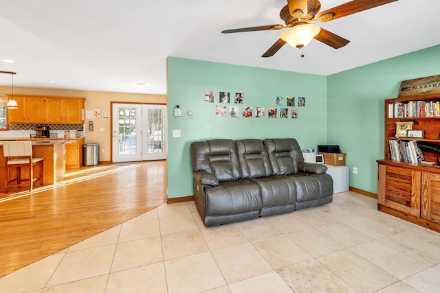 living room with ceiling fan and light tile patterned flooring