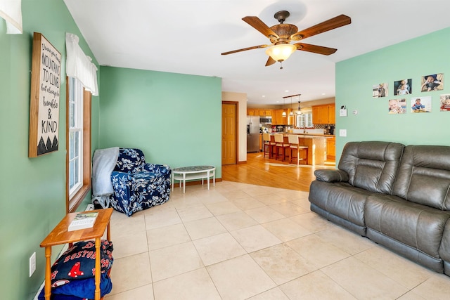 living room with light tile patterned flooring and ceiling fan