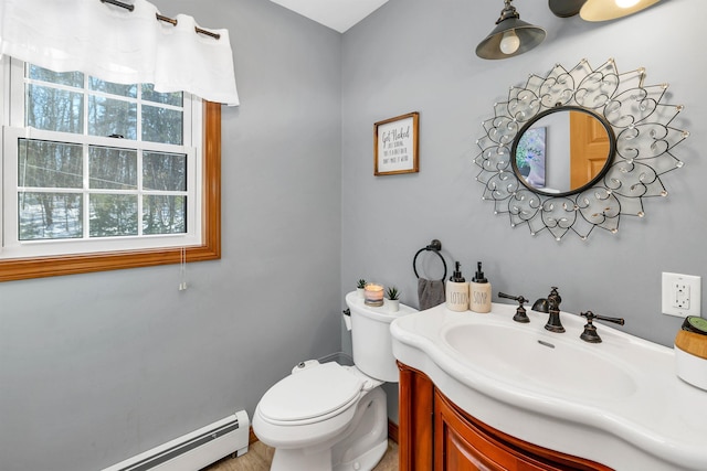 bathroom with a baseboard radiator, toilet, and vanity