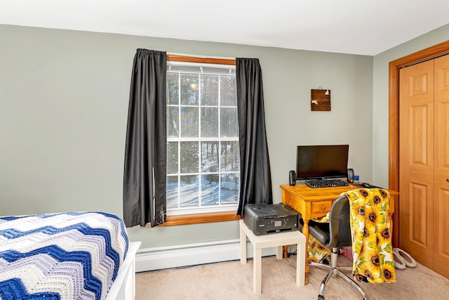 carpeted bedroom featuring a baseboard heating unit and a closet