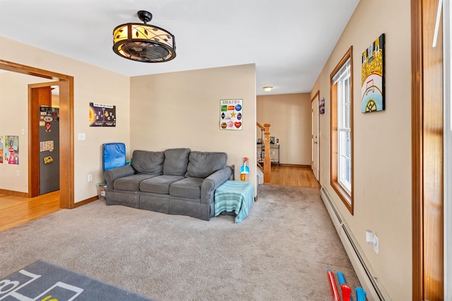 living room featuring baseboard heating and carpet