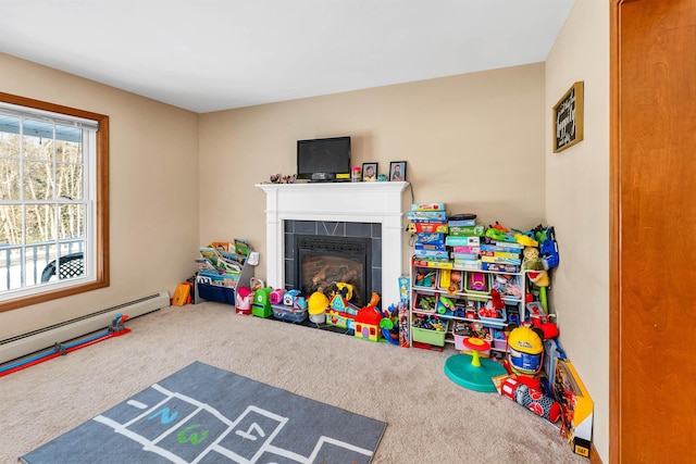 game room featuring a tiled fireplace, carpet floors, and a baseboard heating unit