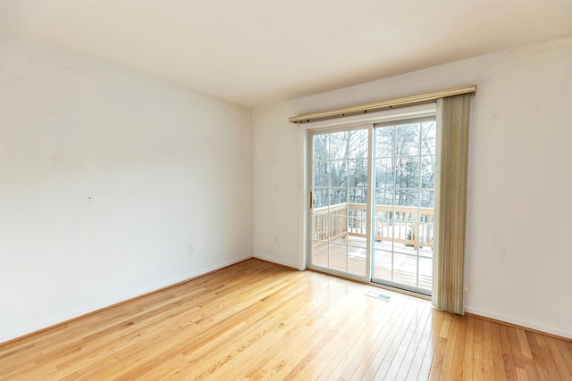 spare room with light wood-type flooring