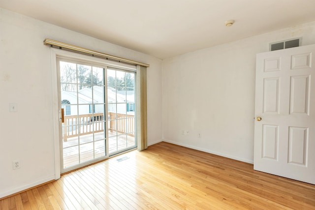 spare room with light hardwood / wood-style flooring