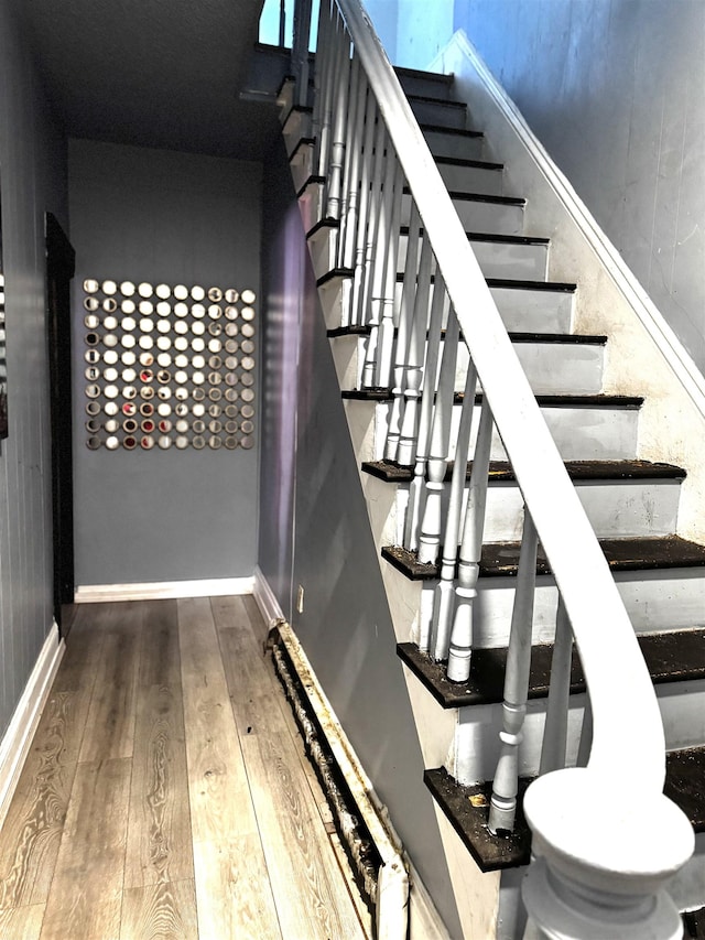 stairway featuring wood-type flooring