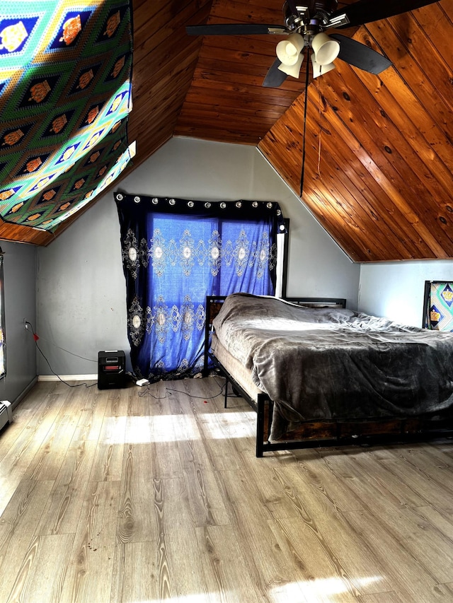 unfurnished bedroom with light wood-type flooring, ceiling fan, and vaulted ceiling