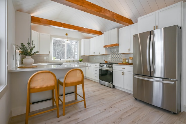 kitchen with white cabinetry, vaulted ceiling with beams, pendant lighting, and appliances with stainless steel finishes