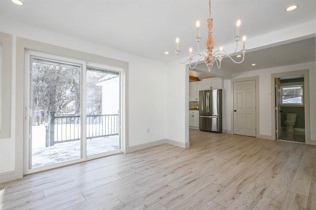 interior space featuring light hardwood / wood-style floors and a chandelier