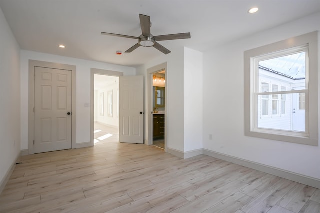 unfurnished bedroom featuring ceiling fan, connected bathroom, and light hardwood / wood-style floors