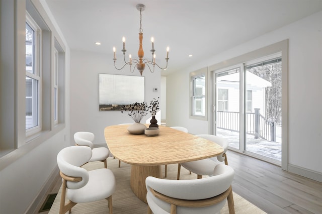 dining room featuring a chandelier, plenty of natural light, and light hardwood / wood-style flooring