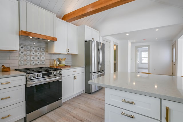 kitchen with light stone countertops, tasteful backsplash, white cabinetry, vaulted ceiling with beams, and stainless steel appliances