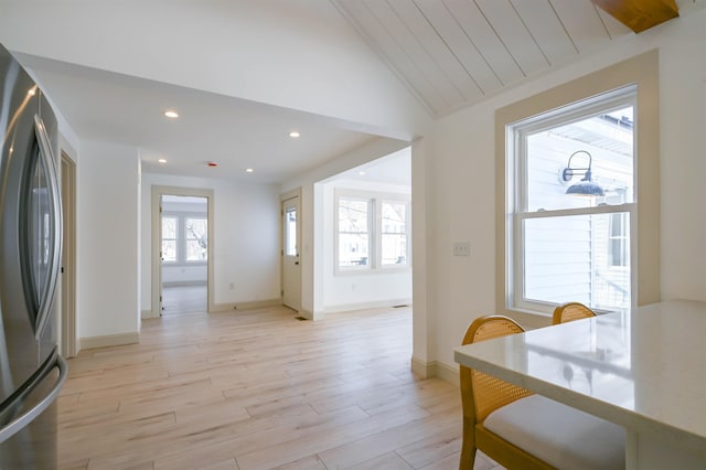 dining area with light hardwood / wood-style flooring and lofted ceiling