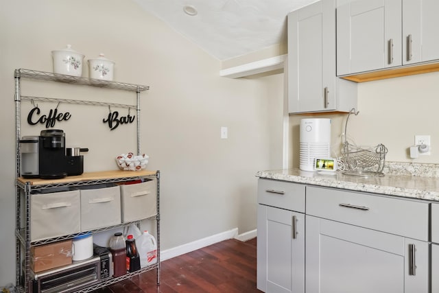 kitchen featuring light stone countertops and dark hardwood / wood-style floors