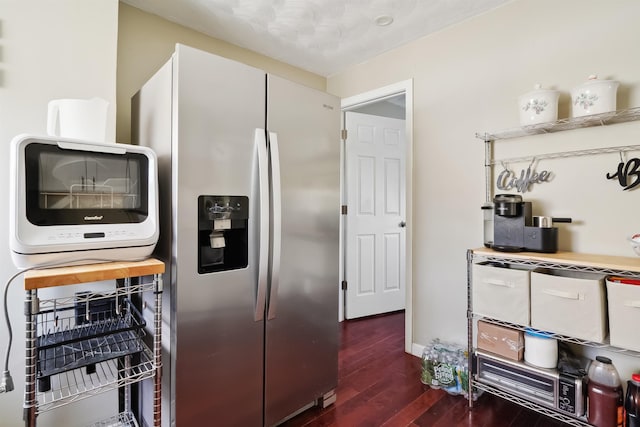 kitchen featuring white cabinetry, dark hardwood / wood-style floors, and stainless steel refrigerator with ice dispenser