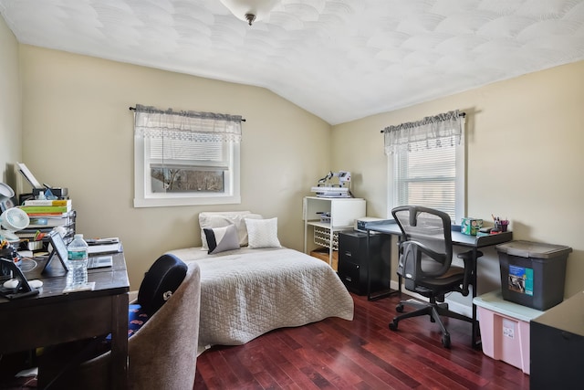 bedroom featuring dark hardwood / wood-style flooring and lofted ceiling