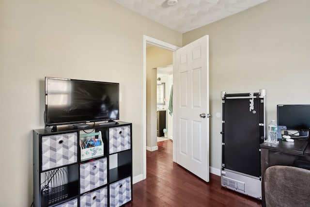 office with dark hardwood / wood-style flooring