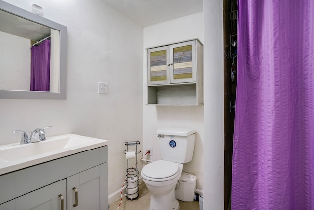 bathroom with vanity, toilet, and tile patterned flooring