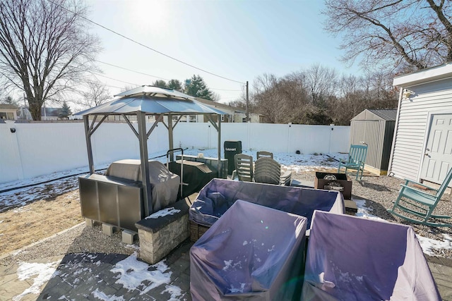 view of patio with a gazebo, grilling area, and a storage unit