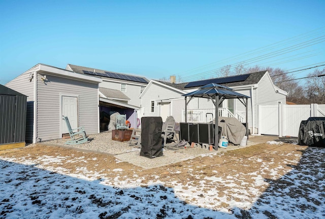 view of snow covered rear of property