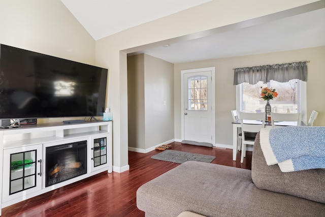 living room with dark wood-type flooring and vaulted ceiling