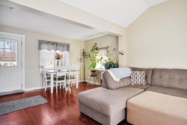 living room featuring dark wood-type flooring and vaulted ceiling