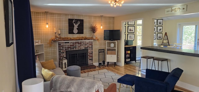 living room featuring hardwood / wood-style flooring and a brick fireplace