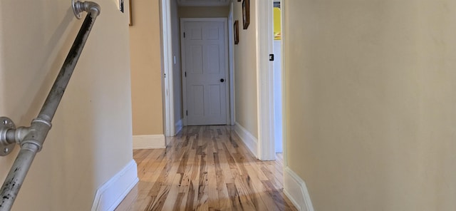 hallway with light hardwood / wood-style floors