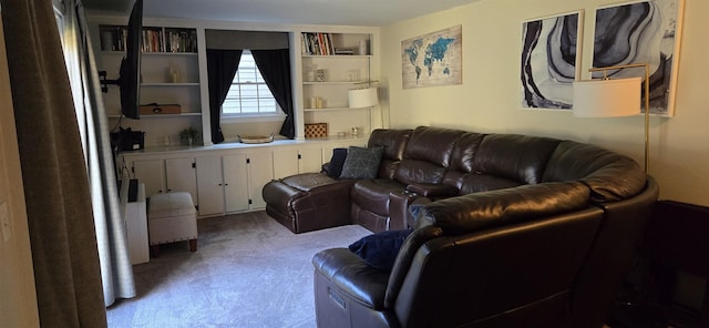 living room featuring built in shelves and light colored carpet