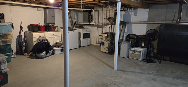 basement featuring electric panel and washing machine and dryer