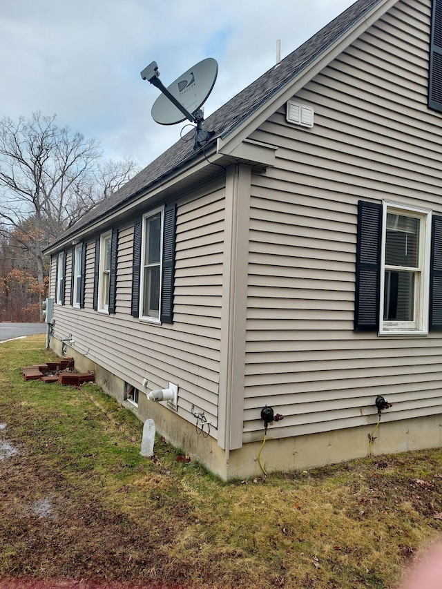 view of side of home with a lawn