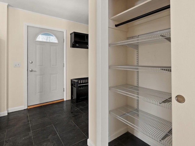 entryway featuring crown molding