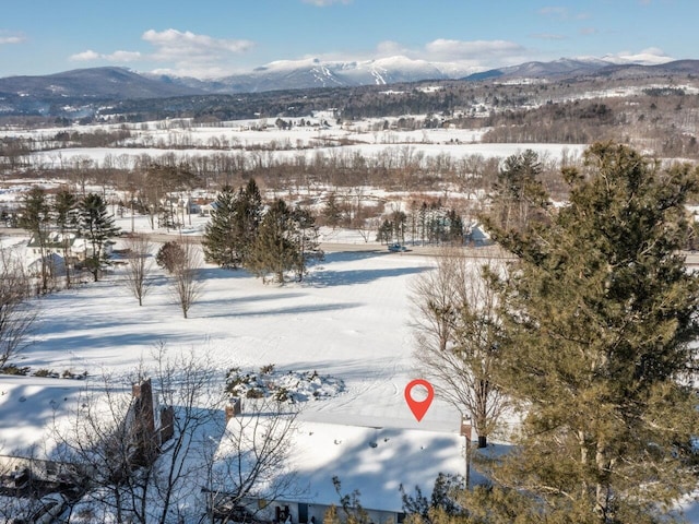 snowy aerial view featuring a mountain view