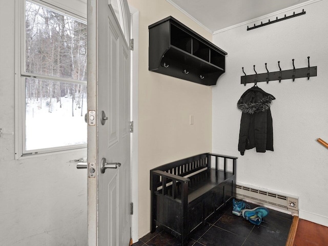 mudroom with a baseboard radiator, ornamental molding, and dark tile patterned floors