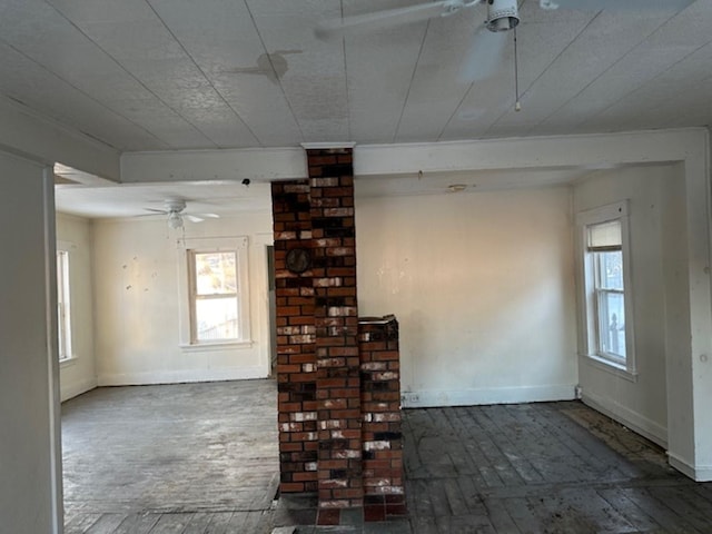 unfurnished living room with ceiling fan and plenty of natural light