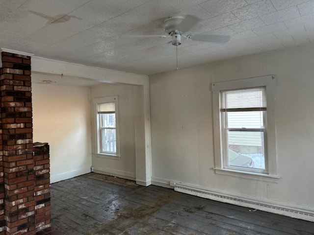 empty room with baseboard heating, plenty of natural light, and ceiling fan