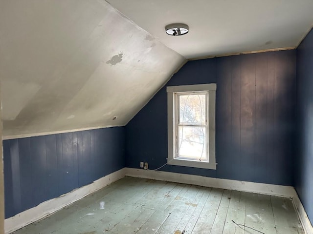 additional living space featuring hardwood / wood-style flooring and lofted ceiling