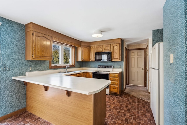 kitchen with sink, white appliances, kitchen peninsula, and a breakfast bar area