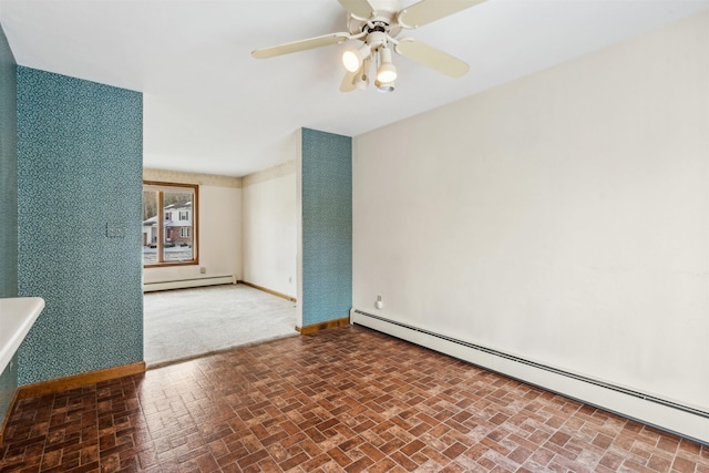 empty room with ceiling fan and a baseboard heating unit