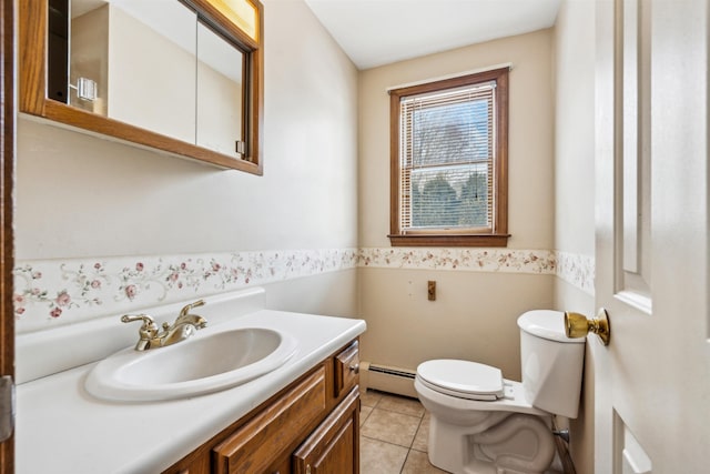 bathroom with a baseboard heating unit, vanity, toilet, and tile patterned flooring