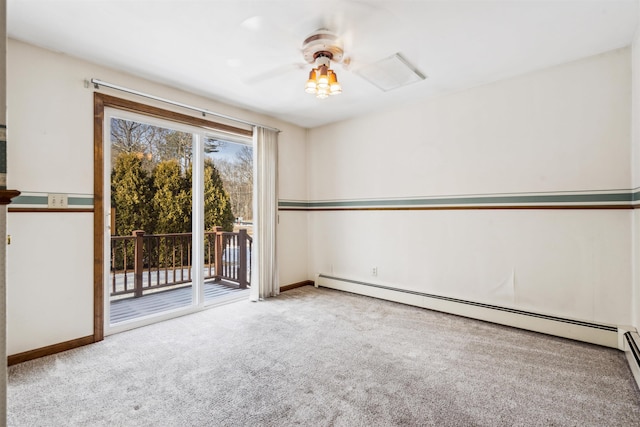 carpeted spare room with a baseboard radiator and ceiling fan